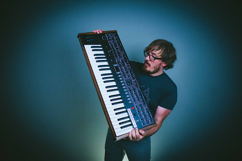 Kyle Andrews with Prophet-6 synthesizer