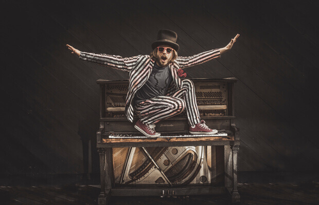 Marco Benevento on top of a piano - photo by Michael DiDonna.jpg